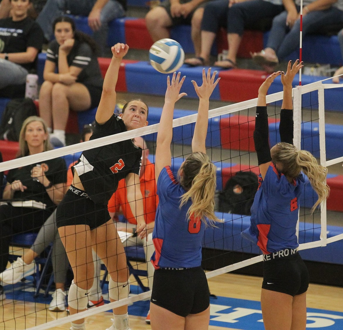 MARK NELKE/Press
Vanessa Kison (2) of Post Falls hits as Aiva Reed (8) and Camryn Farrar of Coeur d'Alene block on Tuesday night at Viking Court.