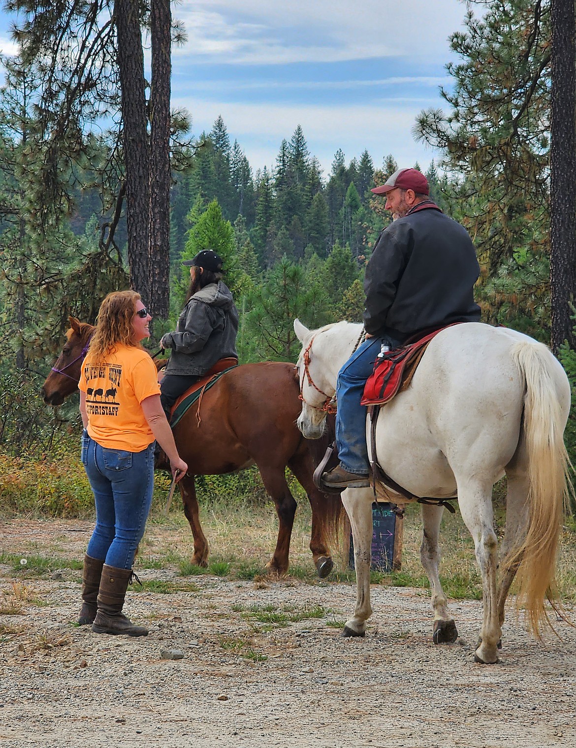 Priest River Valley BCH member Robin Pilkington sends a couple of riders on their way during a past scavenger hunt.