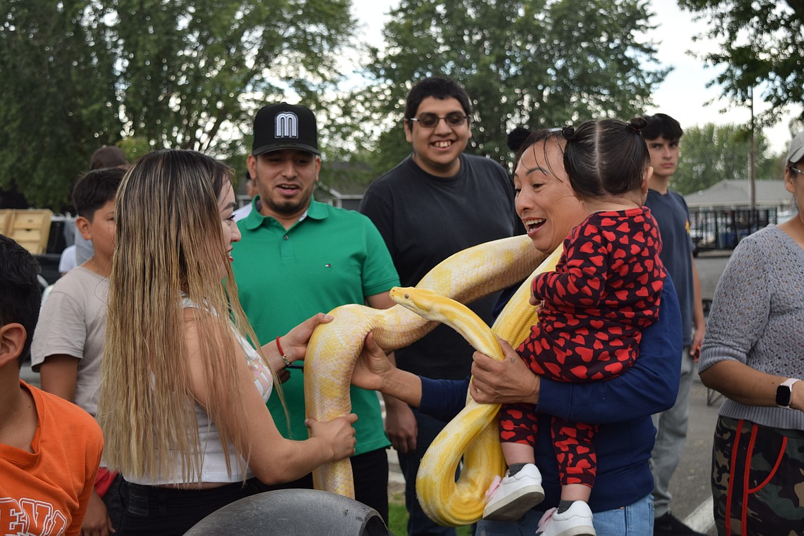 People hold snakes, gators, lizards and turtles at the Warden Community Days event. Scott Peterson, the Reptile Man brought the animals.