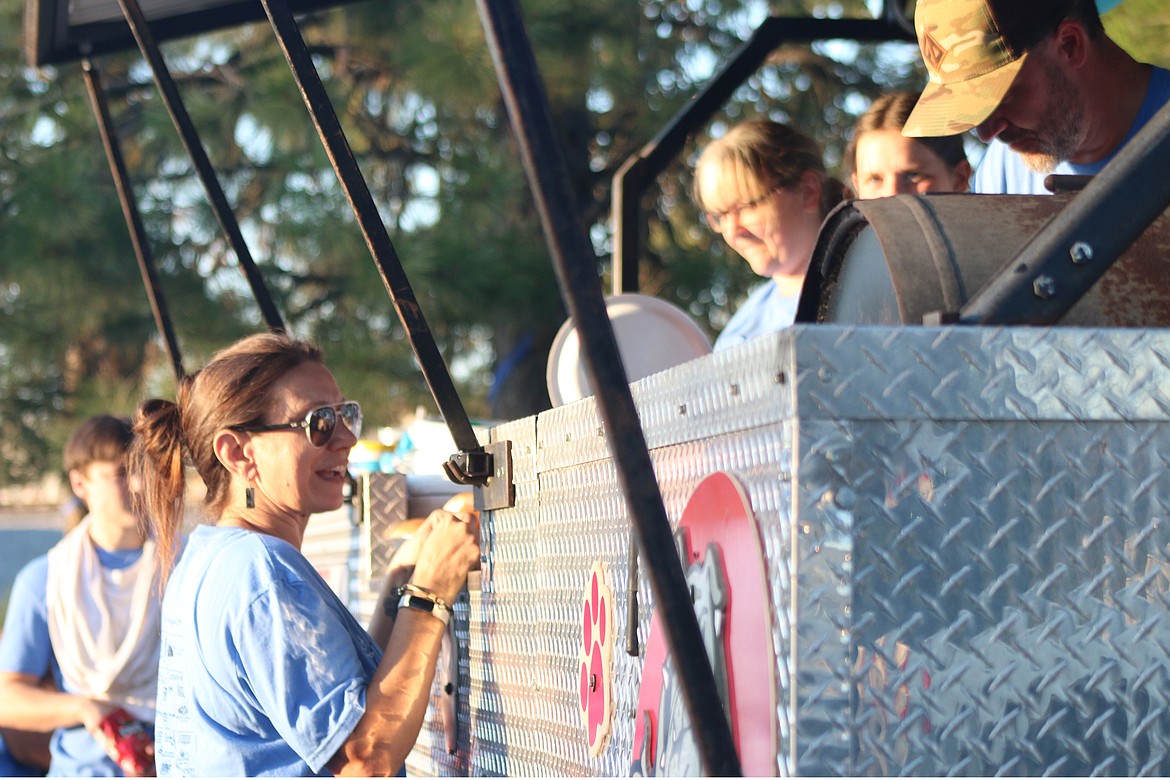 Walk for HOPE volunteers work to cook hamburgers and hotdogs at a community barbecue following the annual event.