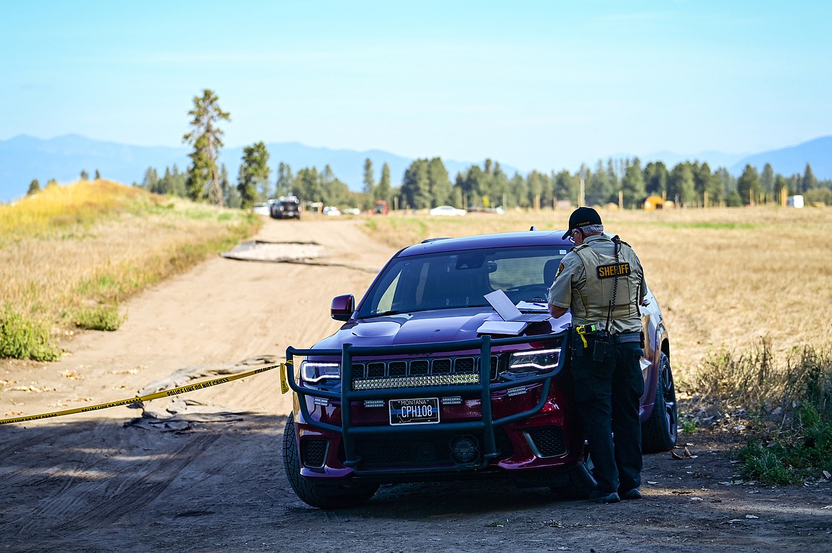 A member of the Flathead County Sheriff's Posse stands at the end of a lane near the scene of a shooting incident along Sullivan Crossroad near Columbia Falls Stage on Wednesday, Sept. 4. (Casey Kreider/Daily Inter Lake)