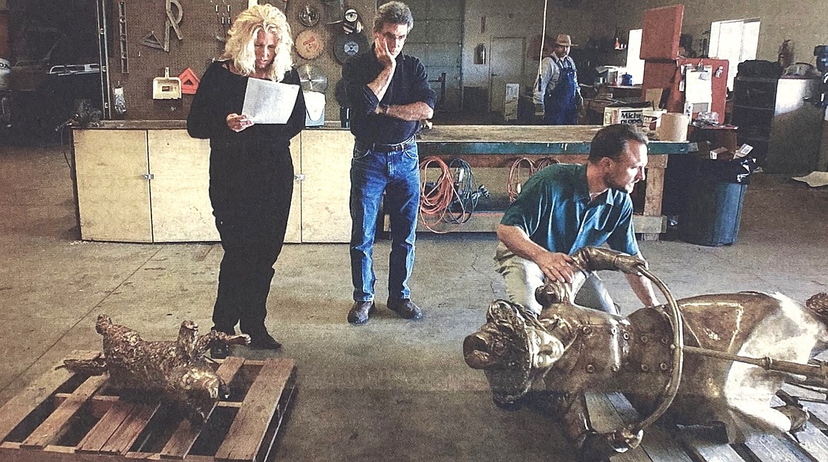 In 2004, artist David Clemons inspected damage to his creation, “Kate,” watched by wife, Sandy, and Kurtis Robinson, director of the county Parks and Waterways Department.