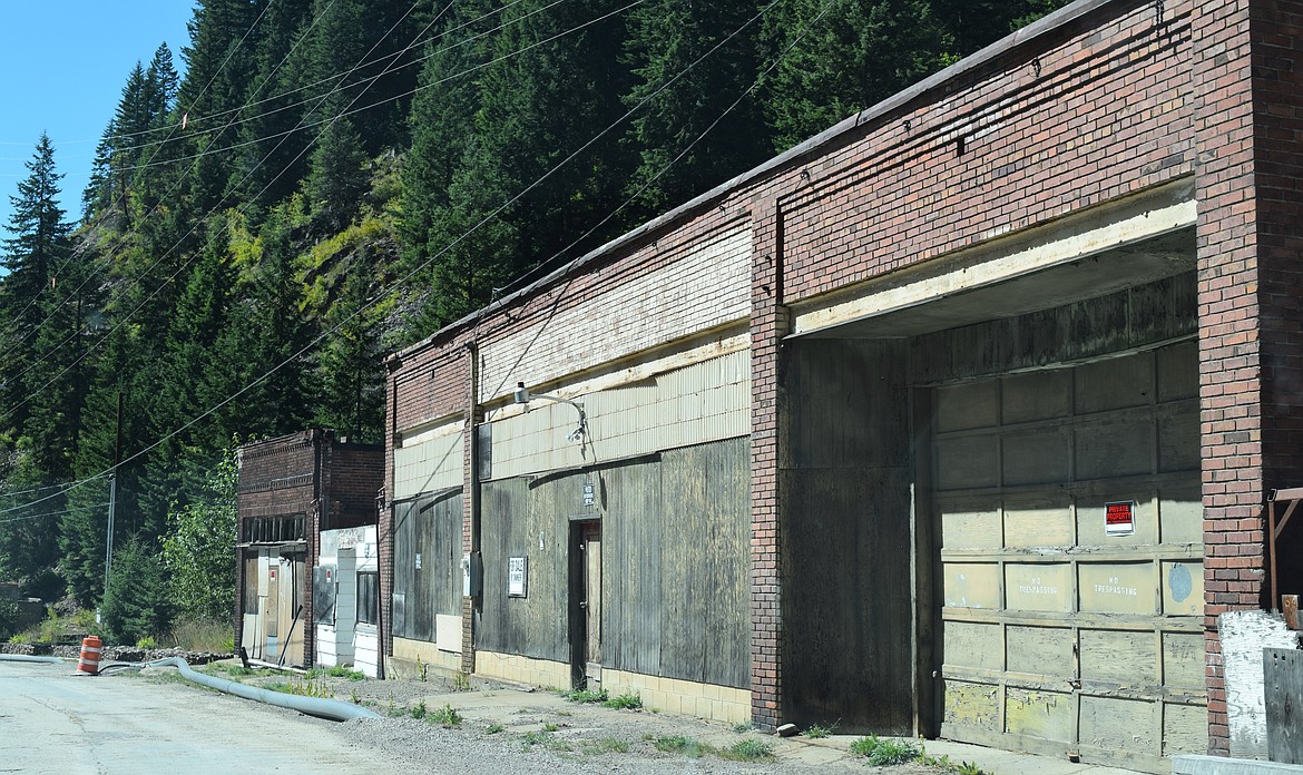 The remaining few commercial buildings in Burke are boarded up and marked with "No Trespassing" signage.