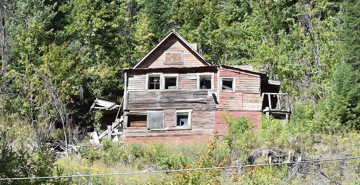 A wooden house stands against the steep canyon walls outside of Burke.