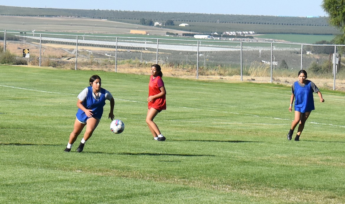 From left: Alejandra Orozco makes a run at the ball with Vanessa Bernal and Kamila Espino at Wednesday’s soccer practice at Royal High School.