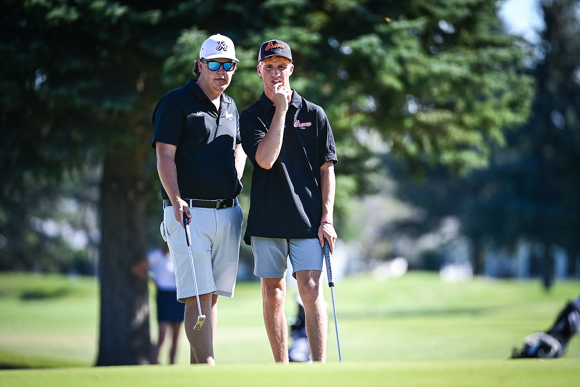 Flathead's Dylan Morris and Korbin Eaton read the second green before putting during the Crosstown Cup at Village Greens on Thursday, Sept. 5. (Casey Kreider/Daily Inter Lake)