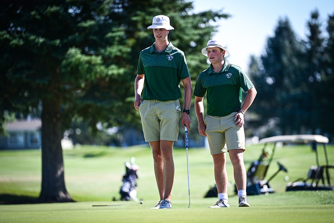 Glacier's Sam Engellant and Torren Murray talk before before putting on the second green during the Crosstown Cup at Village Greens on Thursday, Sept. 5. (Casey Kreider/Daily Inter Lake)