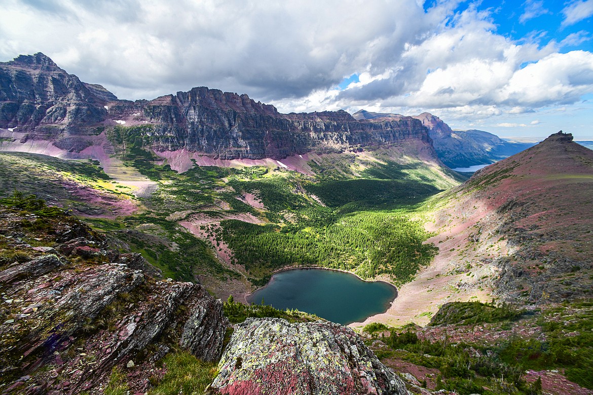 Cobalt Lake sits below Mount Rockwell, left, Sinopah Mountain, center, and Painted Teepee Peak, right, along the Two Medicine Pass Trail in Glacier National Park on Wednesday, Aug. 21. (Casey Kreider/Daily Inter Lake)