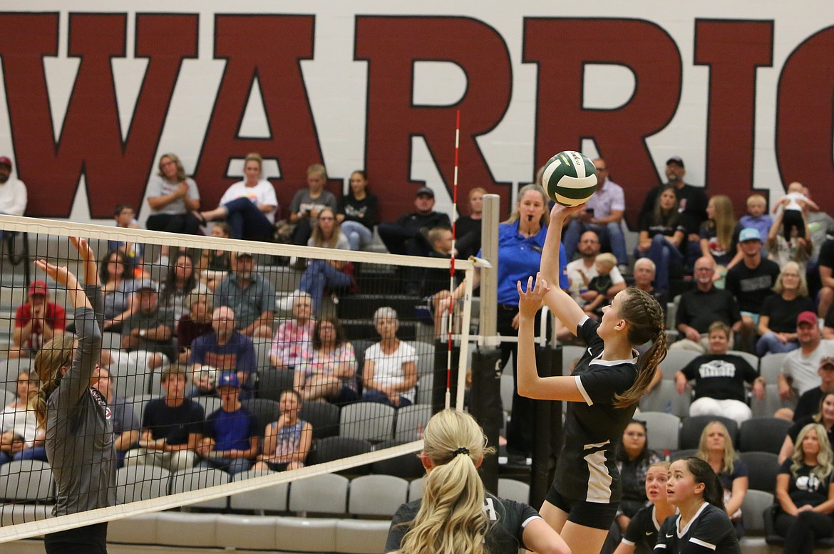 Warrior graduate Natalie Evers aims to tip the ball over the net during a game last season. Evers is one of five Warriors from last year’s roster who graduated in the spring, all of which were starters.