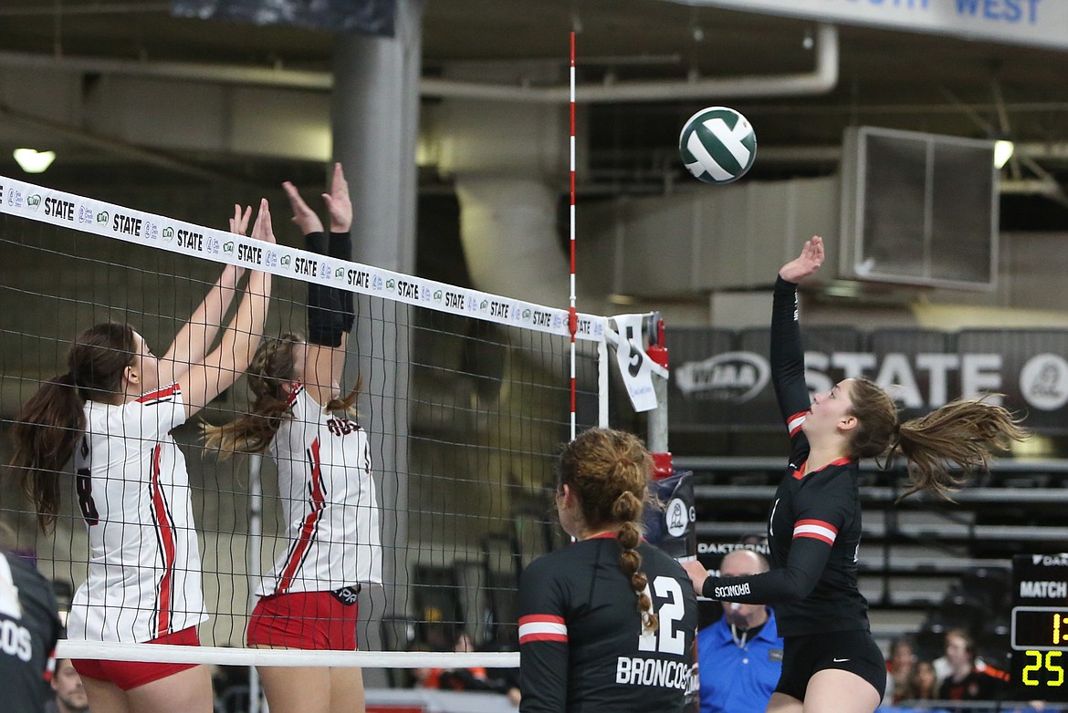 Lind-Ritzville/Sprague junior Zoe Galbreath, right, tips the ball over the net during a state tournament game against Coupeville. Galbreath is the reigning Northeast 2B league co-MVP.