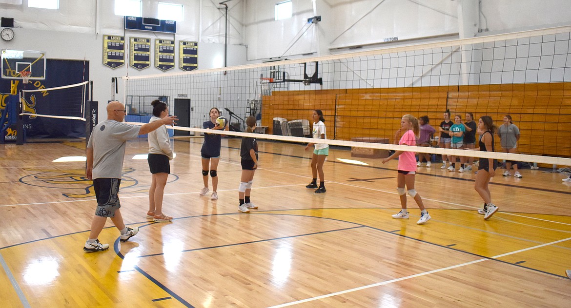 Moses Lake Christian Academy/Covenant Christian School Head Coach Dean Spurbeck, left, addresses his squad at Moses Lake Christian Academy/Covenant Christian School volleyball practice Aug. 30.