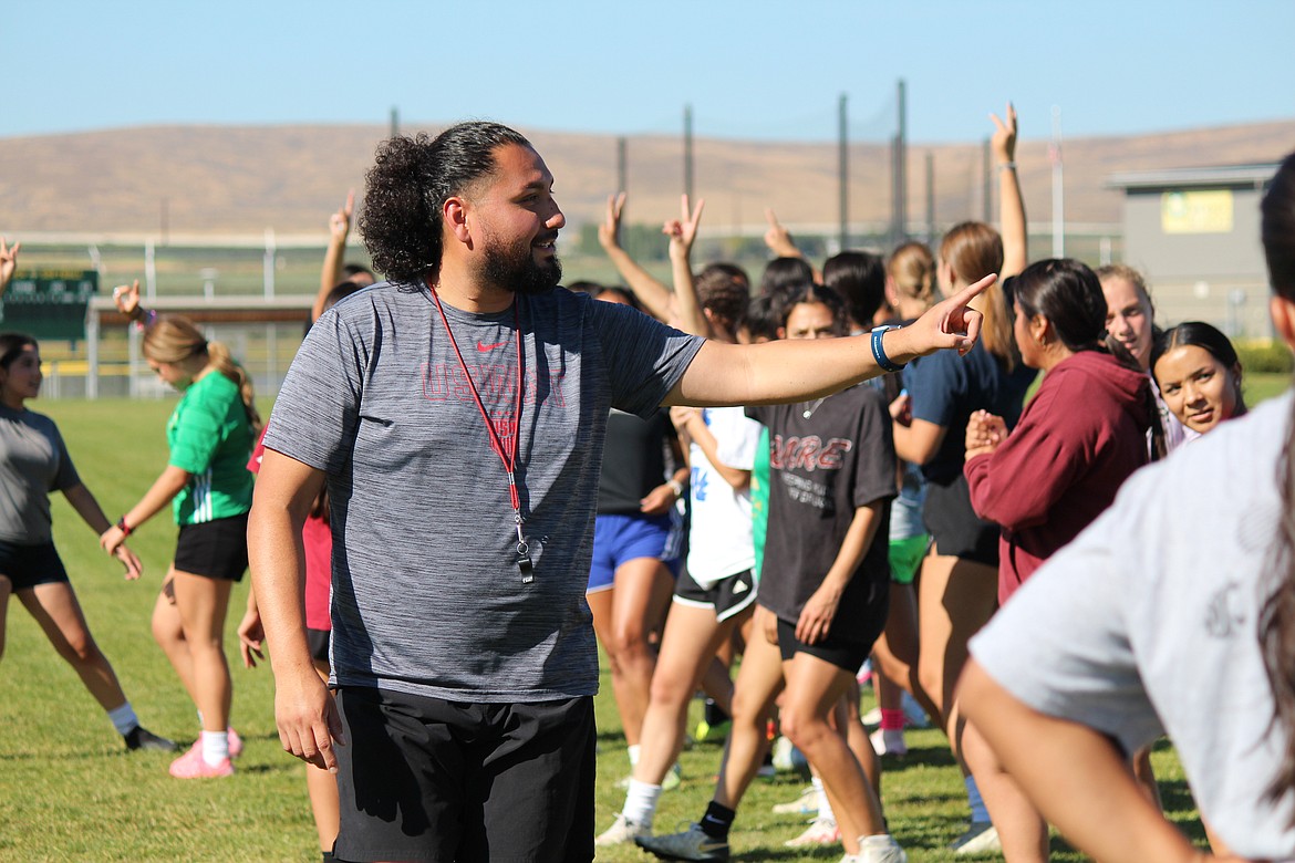 New Quincy girls soccer Coach Jesse Villalobos directs traffic at an early-season practice.