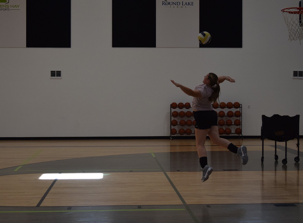 Wilson Creek Volleyball co-captain Neeley Odorizzi leaps up for a power serve during practice at the Stevens Hay Gym Tuesday. Odorizzi is one of the few seniors on the team.