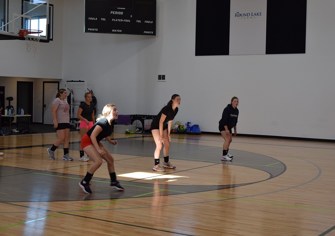 The Wilson Creek Devils volleyball squad runs drills during a Tuesday practice. Their drill was focused on communication and mobility on the court.