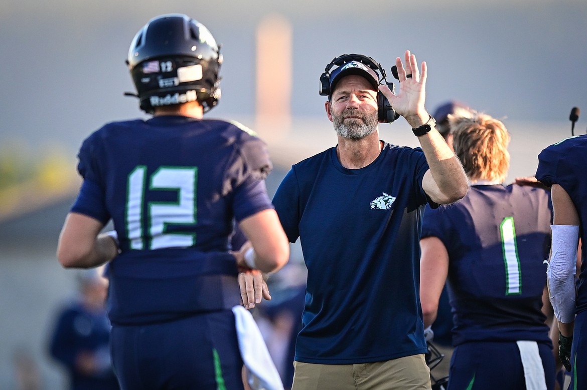 Glacier head coach Grady Bennett congratulates quarterback Jackson Presley (12) after a first-quarter touchdown against Billings Senior at Legends Stadium on Friday, Sept. 6. (Casey Kreider/Daily Inter Lake)