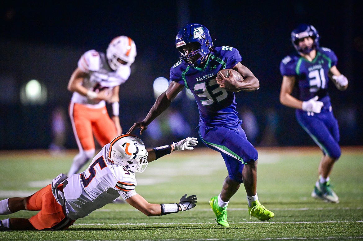 Glacier running back Kobe Dorcheus (33) gets around the edge on a run in the fourth quarter against Billings Senior at Legends Stadium on Friday, Sept. 6. (Casey Kreider/Daily Inter Lake)