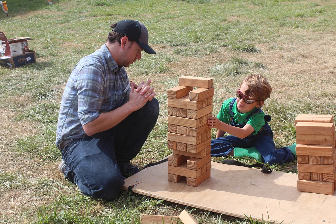 Mark, left, and Henry Campbell play a game at the Kids Zone at last year’s Othello Fair. The Kids Zone is something the fair organizers are especially proud of: a place where young fairgoers can hangout and just be kids.