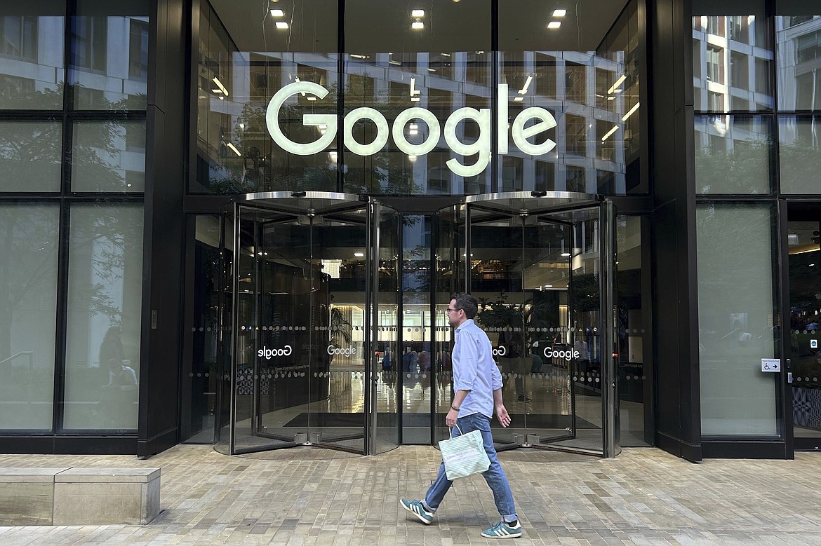 A man walks past Google's offices in London's Kings Cross area, on Aug. 10, 2024. (AP Photo/Brian Melley)