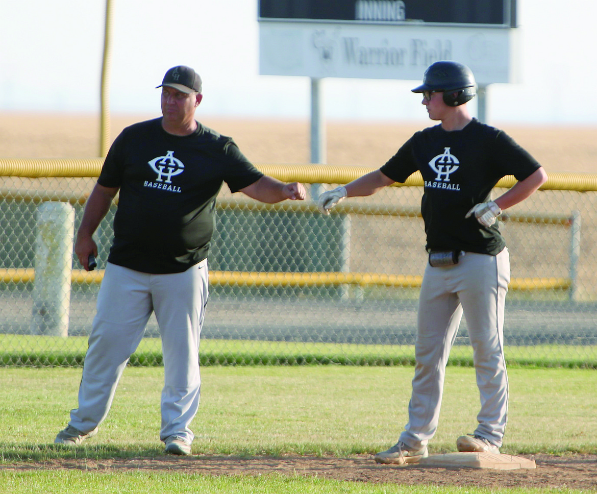 Almira/Coulee-Hartline Legion Head Coach first-bumps second baseman Caden Correia after reaching third base during a game against Gonzaga Prep on July 12 in Hartline. Correia started the ACH Legion baseball team last year, giving players in the area an opportunity to continue playing over the summer.