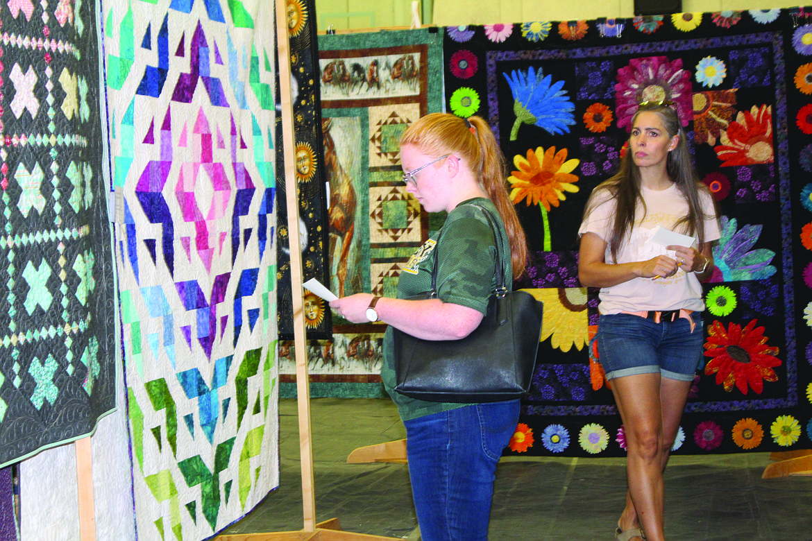 A quilt show attendee picks her favorites at FCAD 2023.