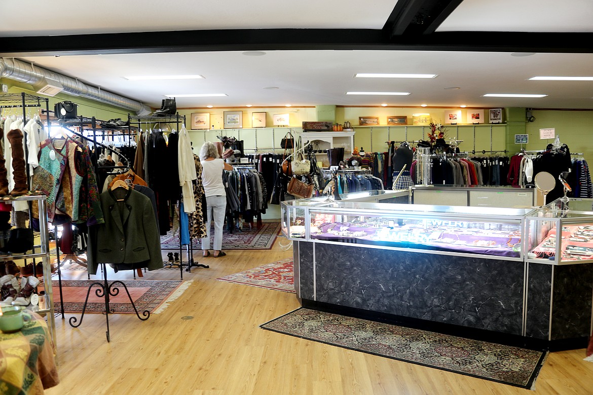 A Community Assistance League member puts finishing touches on the inside of Bizarre Bazaar as the longtime community group celebrated the grand opening of the store's new Boyer Avenue location.