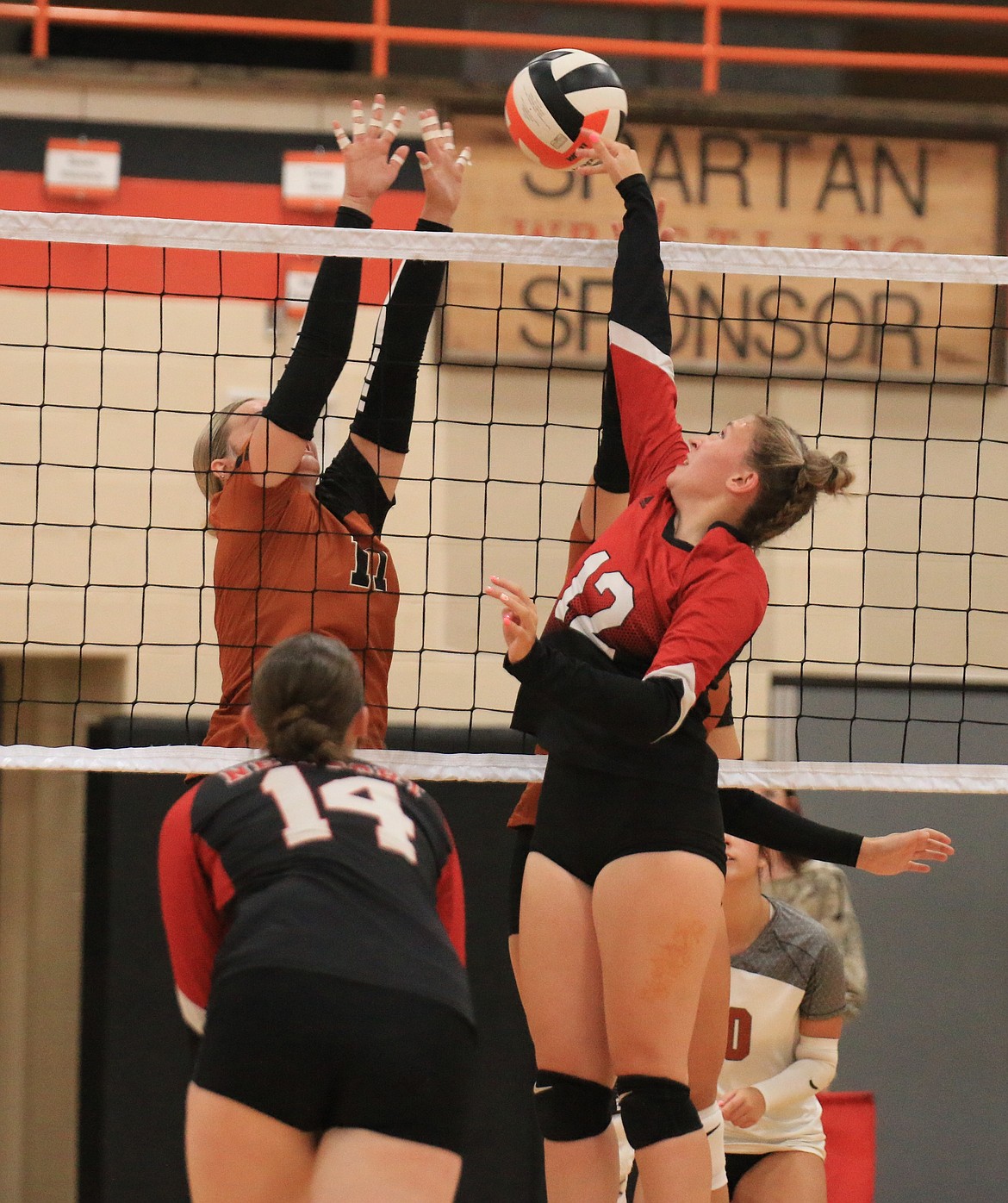 Priest River High junior Aleigha Jensen blocks a Griz attacker during Saturday night's game.