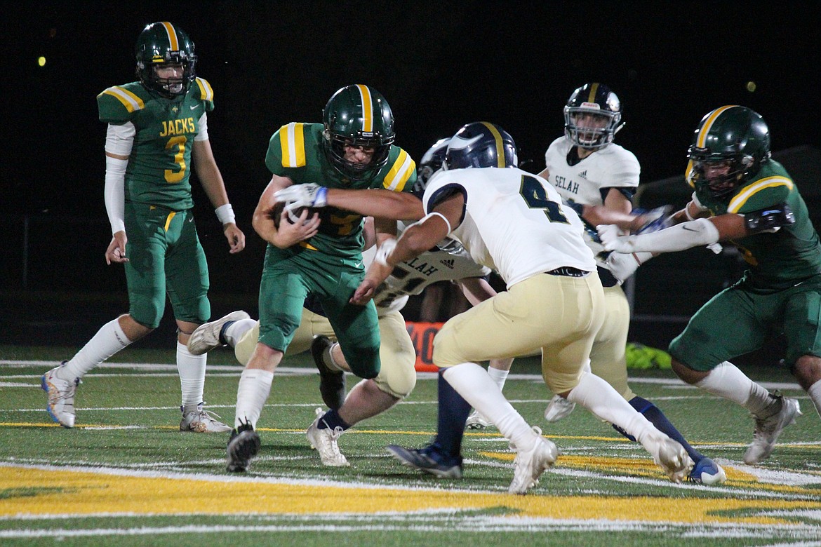 Jaxson Ferguson (14) confronts a Selah defender in Quincy’s season-opening loss Friday.