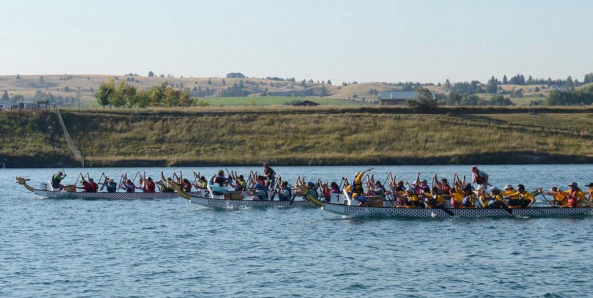 Three dragon boats race for the finish line on the Flathead River in the 200-meter course, during last Saturday's Montana Dragon Boat Festival in Polson. (Kristi Niemeyer/Leader)