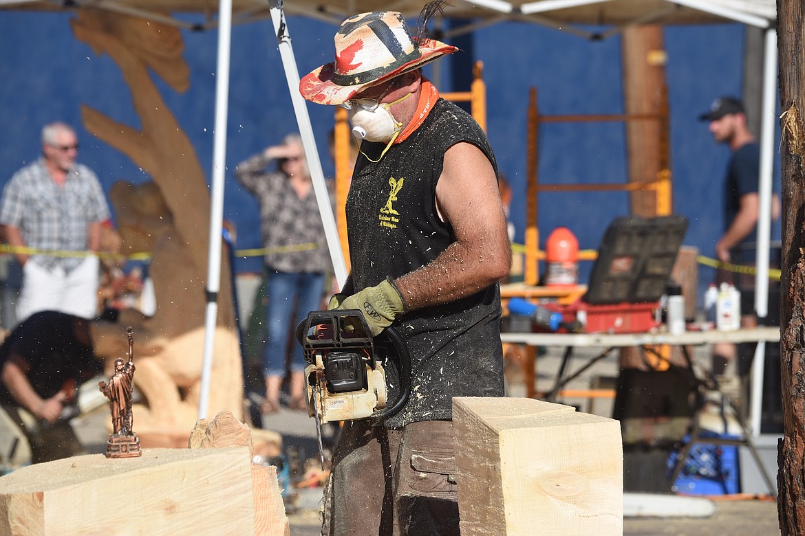 Chainsaw carver Emil Szkipala works on his creation Friday, Sept. 6, 2024, at the Clash of the Carvers International Chainsaw Carving Competition. (Scott Shindledecker/The Western News)