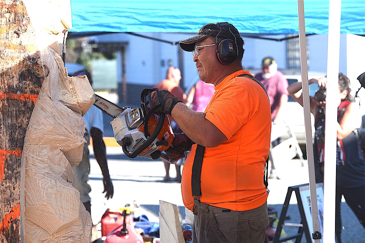 Chainsaw carver George Dorjsuren works on his creation Friday, Sept. 6, 2024, at the Clash of the Carvers International Chainsaw Carving Competition. (Scott Shindledecker/The Western News)