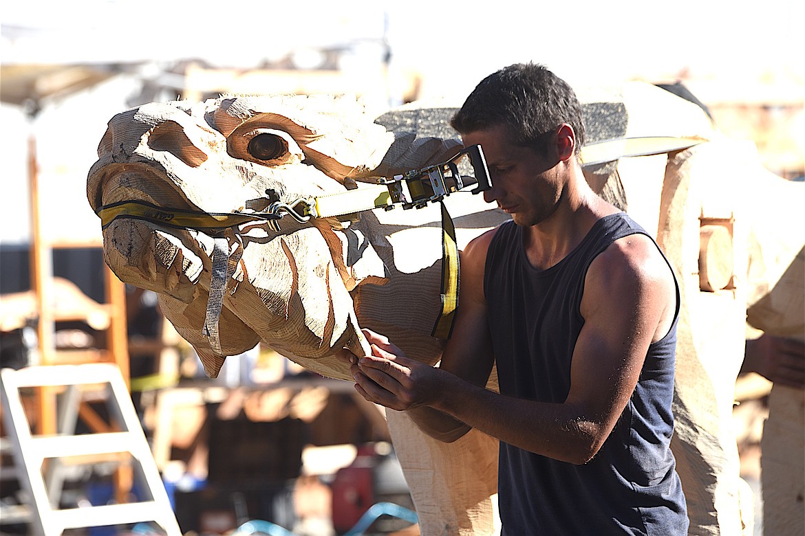 Chainsaw carver Raimondas Uzdravis works on his creation Friday, Sept. 6, 2024, at the Clash of the Carvers International Chainsaw Carving Competition. (Scott Shindledecker/The Western News)