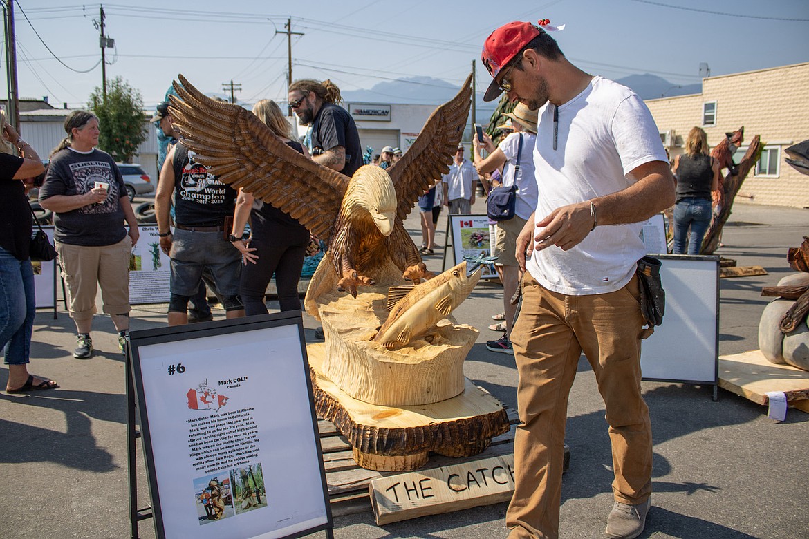 Wood carving fans admire the works of art at the Kootenai Country Montana International Chainsaw Carving Championships. (Taylor Resch/The Western News)