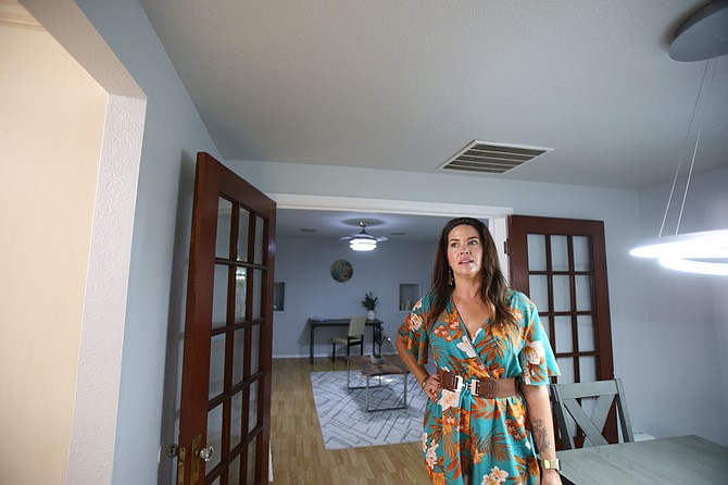 Lisa Biondo, a Realtor at Windermere Coeur d'Alene Realty, discusses the process of flipping a house Sept. 9 while visiting a 1914 downtown Coeur d'Alene home she fixed up and just put on the market after using it as a short-term rental. “I kind of like the old and the new,” she said.