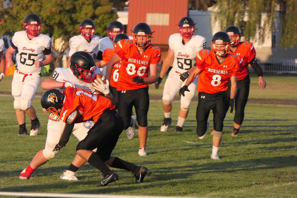 Plains defenders converge on a Darby ball carrier during their game Friday night in Plains.  (Chuck Bandel/VP-MI)