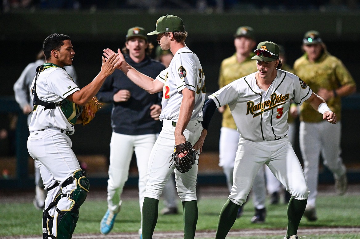 Range Riders reliever Noah Owen (32) celebrates with Freddy Guilamo (19) and Ty Penner (3) after getting the six-out save against Missoula at Glacier Bank Park on Tuesday, Sept. 10. (Casey Kreider/Daily Inter Lake)