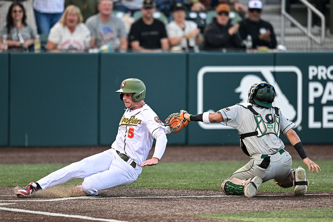 Glacier's Ryan McCarthy (5) scores a run on a single by Christian Kirtley in the first inning against Missoula at Glacier Bank Park on Tuesday, Sept. 10. (Casey Kreider/Daily Inter Lake)