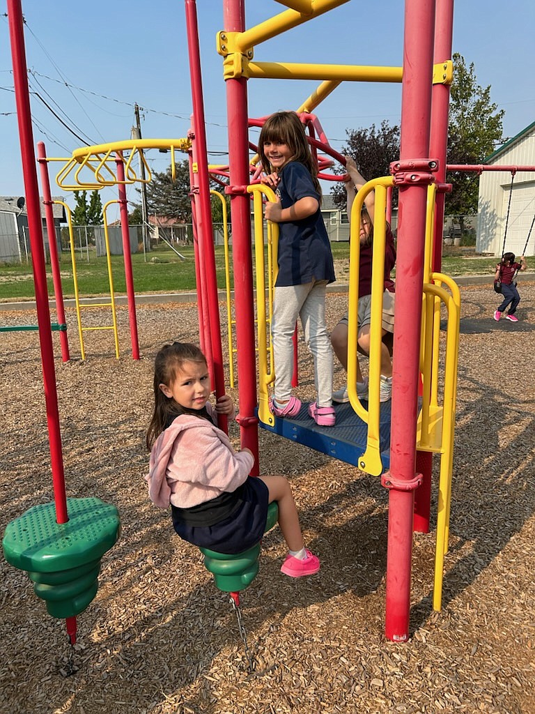 Cordelya Ridgeway (sitting) and Delanie Palmer enjoy recess at Crestview Christian School.