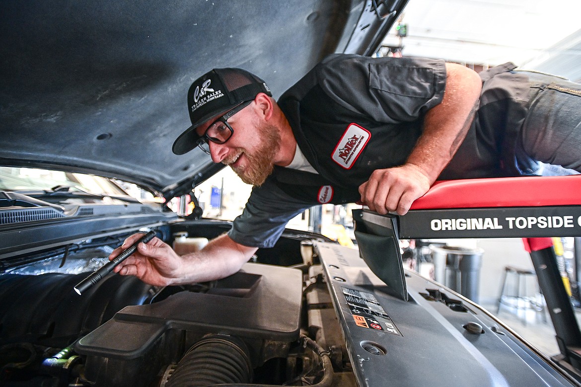 Technician Shawn Henry works under the hood of a Chevrolet Suburban at Noller Automotive Supercenter on Tuesday, Sept. 10. (Casey Kreider/Daily Inter Lake)