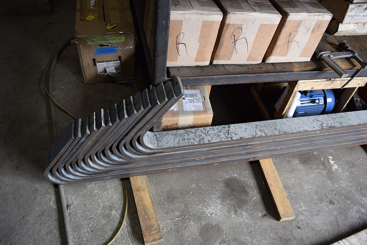 Flat steel bars with a curve at the end are created toward the beginning of the process to make a Callahan brand hoist. I-beam style supports make for stronger products than tube supports, Dean Callahan said.