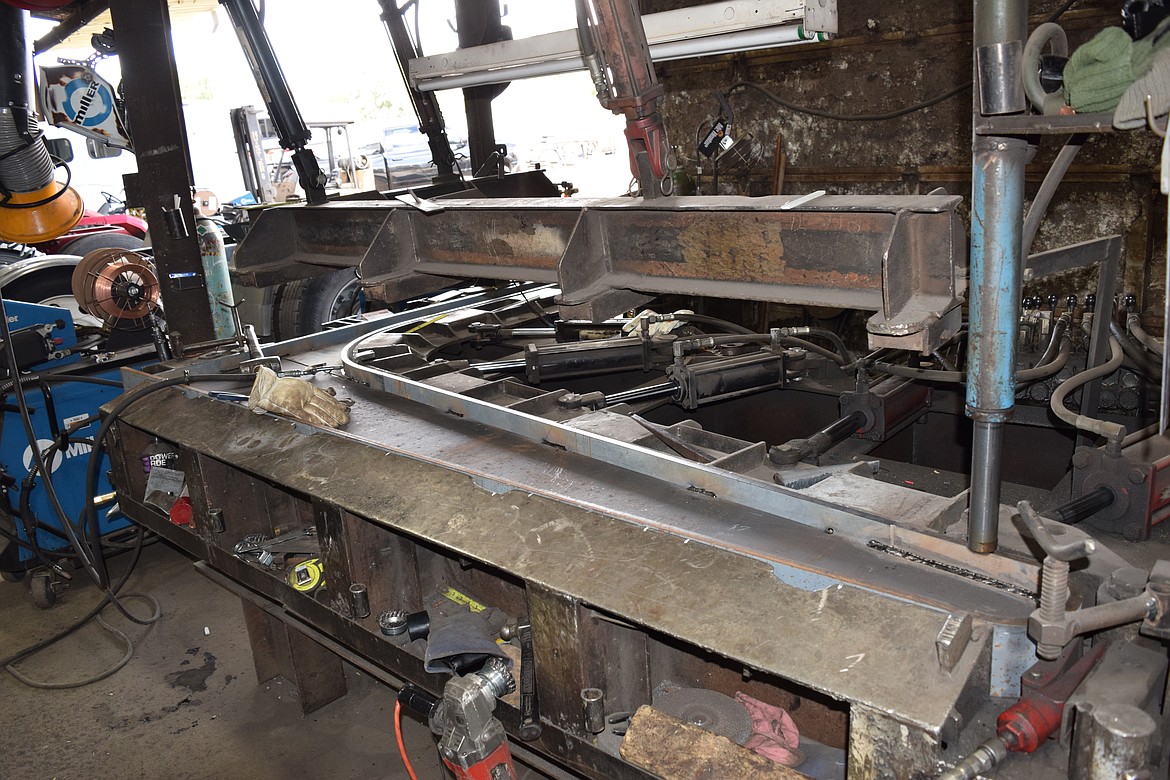 Once the pieces for one of the side supports for a hoist are assembled, they’re pressed together by this machine and then welded on a nearby fixture to hold their shape.