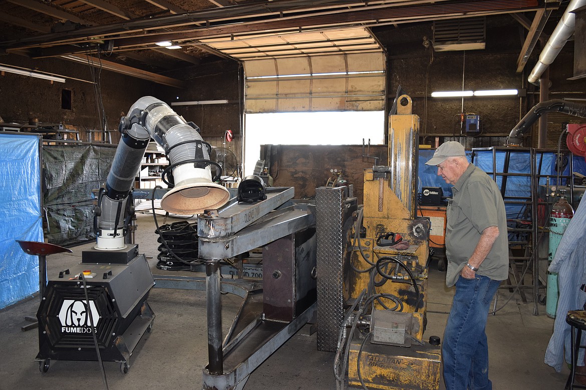 Dean Callahan shows how one of the special fixtures in the Callahan Manufacturing facility rotates the hoists so that the various pieces can be welded safely and with better quality.