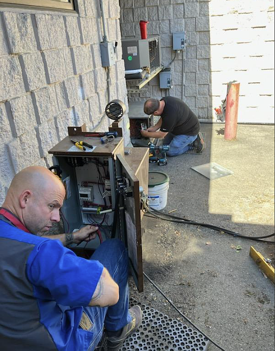 Maintenance foreman Jasper Kohoutek, left, and Kyle Zimmerman, kitchen maintenance technician, conduct work at Fernan STEM Academy this summer. The Coeur d'Alene School District and industry partners completed about $3.5 million in maintenance, security and repair work while students were out of school.