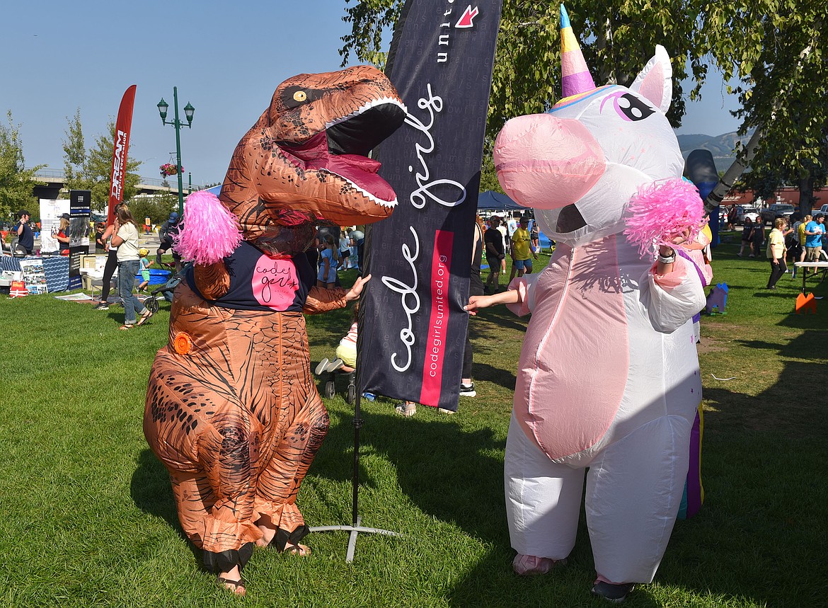 Dinosaur Isabelle Ashley and unicorn Mikayla Davenport cheer for Code Girls United at the Great Fish Community Challenge Fun Run. Code Girls United provides experiences in coding, technology and business for young girls. (Kelsey Evans/Whitefish Pilot)