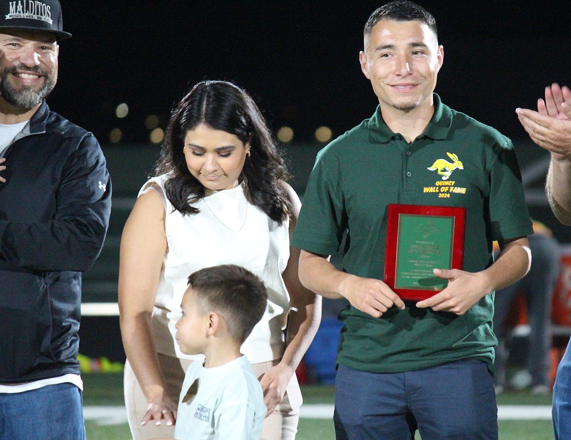 Accompanied by family and friends, Francisco Alejandrez, left, is inducted into the Quincy Wall of Fame Friday.