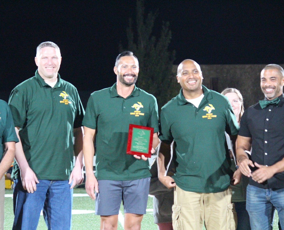 The 1997 state champion 4x400 boys relay team, from left, Devin Howe, Brian Harrington, Cory Medina and Walter Brisbon, were inducted into the Quincy High School Wall of Fame Friday.