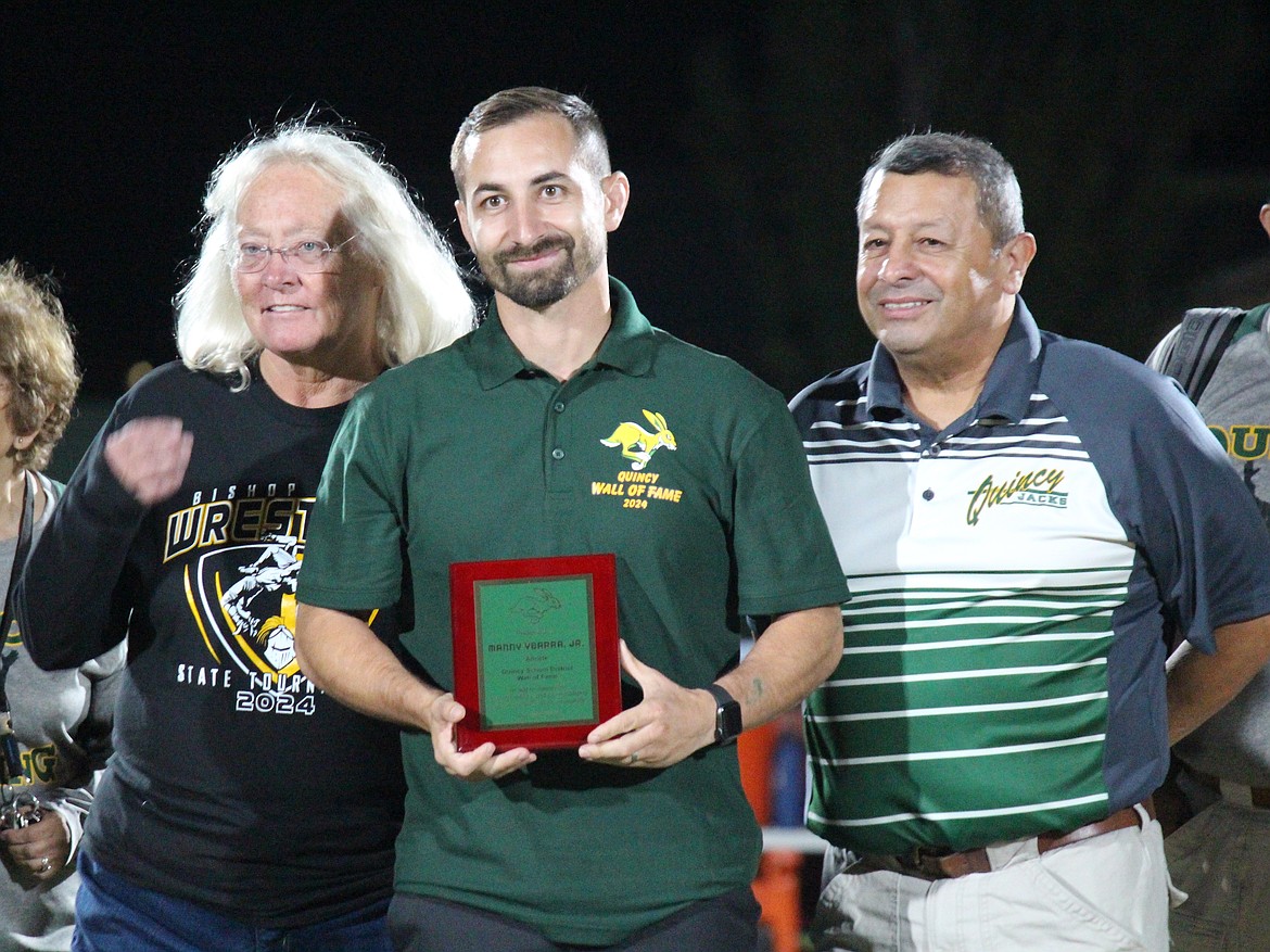 Manny Ybarra Jr., center, was one of seven Quincy athletic legends inducted into the school’s Wall of Fame Friday.