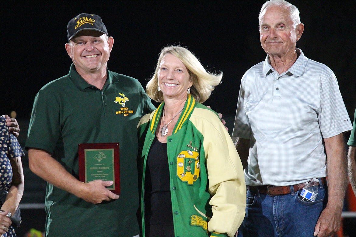 Wade Gebers, right, accepted his induction plaque for the Quincy High School Wall of Fame with family and friends in attendance.