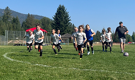 Photo by ALYSSA McLEMORE
The Sting Soccer Club 2016 boys Black soccer team competed at the Pend Oreille Cup last weekend in Sandpoint. On Saturday morning, the Sting beat the Spokane Sounders Shadow Basel Valley 8-1. Sting Black goals were scored by Lincoln Treibwasser, Kellen McLemore, Jackson Martin and Peter Ward. Saturday afternoon, the Sting tied the BVBIA CDA Black 5-5. Black goals were scored by Jackson Martin and Eli Hocking. Sunday morning, the Sting fell 5-3 to the BVBIA CDA Black in the semifinals. Sting Black goals were scored by Oliver Lundy and Jackson Martin.
Pictured are Sting Soccer Club Black team members, with head coach Ian McKenna.