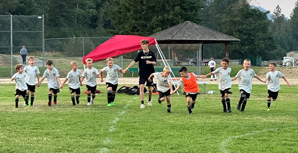 Photo by NICOLE HELBLING
The Sting U9 boys Yellow soccer team competed in the 2024 Pend Oreille Cup last weekend in Sandpoint. Saturday morning, the Sting lost 5-3 to the Spokane Sounders Shadow Juniors B2016 Van Der Lawson Valley team. Sting goals were scored by Elijah Cline (1), Gideon Lee (1) and Jaxson Matheney (1). Saturday evening, the Sting beat the Sandpoint Strikers FC 2016B Black team 5-0, with goals scored by Elijah Cline (3), Hudson Helbling (1) and Isaak Sterling (1). Sunday morning, the Sting fell 11-1 to the Glacier Surf Soccer Club 2016 Boys Blue team. The Sting goal was scored by Isaak Sterling. Pictured from left are Athanasius Berry, Micah D’Alessandro, Lincoln Sargent, Hudson Helbling, Elijah Cline, Isaak Sterling, assistant coach Landon Lee, Gideon Lee, Xavier Sousley, Bodhi Christopherson, Jaxson Matheney and Xander Rodriguez.