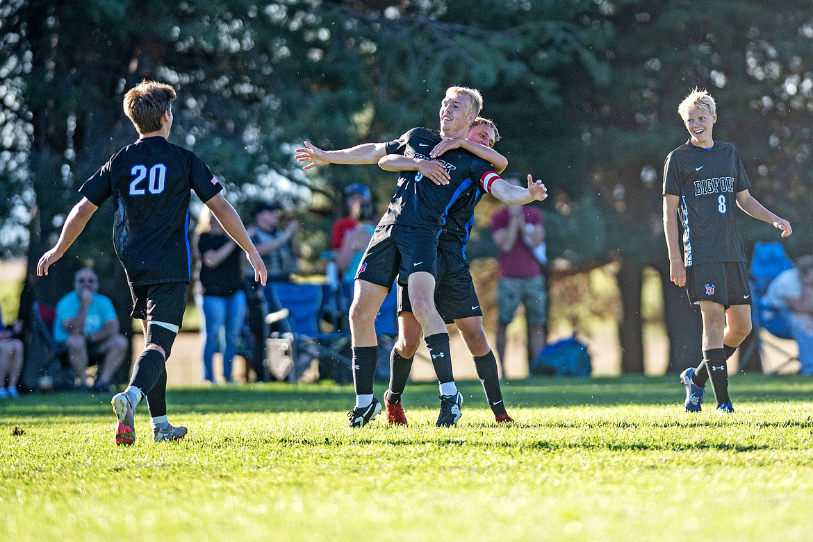 Robert Merchant (center) is celebrated by his teammates after scoring on Libby Thursday. (Avery Howe/Bigfork Eagle)